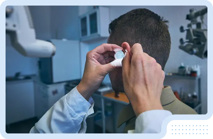 ENT specialist examining ear using otoscope device