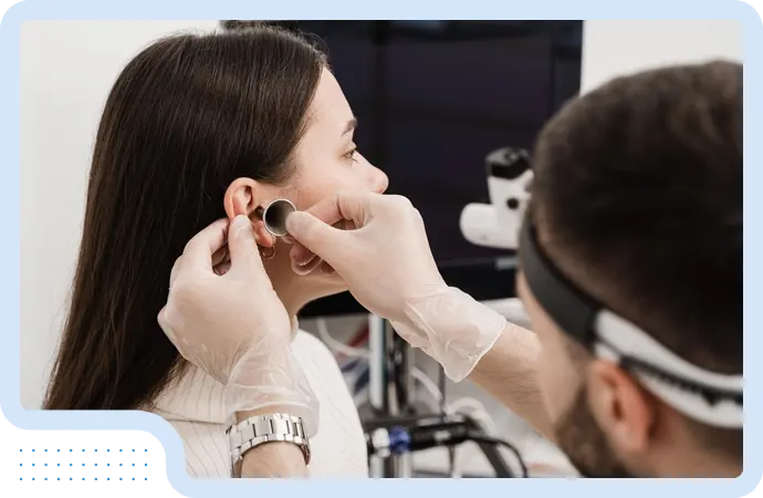 Audiologist fitting hearing aid device for patient with hearing loss